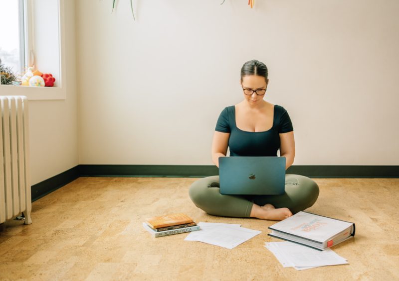 Amite Yoga Training Day 2 13 of 291 Yogi Seated cross-legged while working on laptop