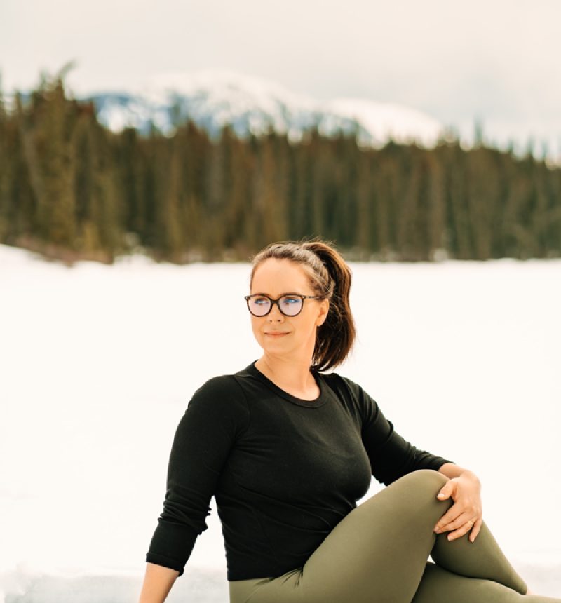Amite Yoga – Winter Session 83 of 111 Yogi doing seated side twist in the snow