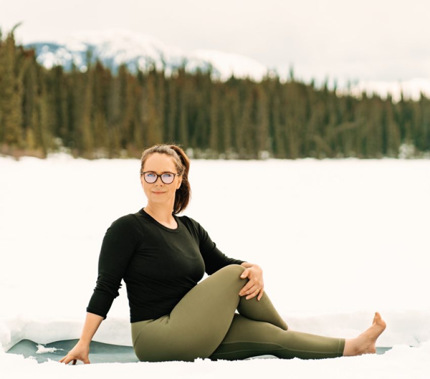Amite Yoga – Winter Session 84 of 111 Yogi sitting in snow doing seated side twist