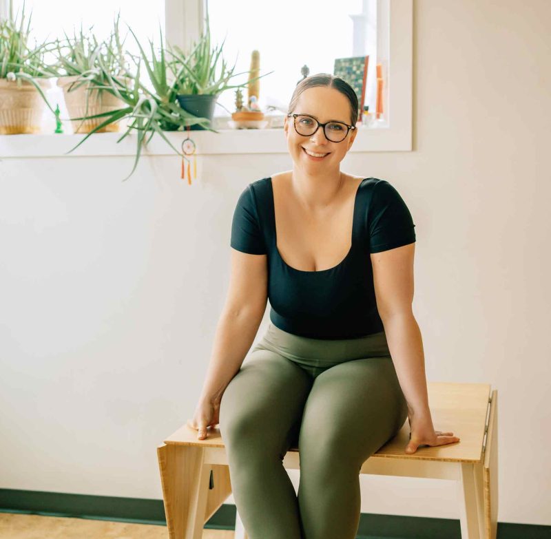 YTT_YogaTeacherTraining_AmitieYoga7 Amitié Yoga - Darci Nyal, E-RYT 500 Sitting on table smiling
